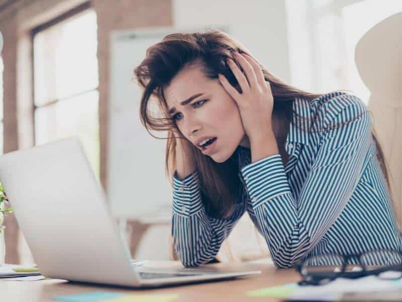 Frustrated woman at a laptop